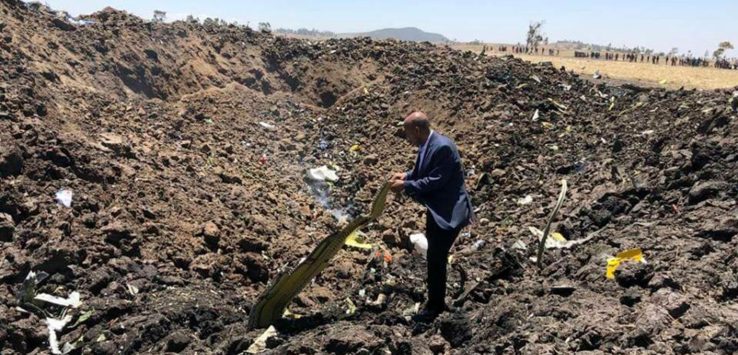 a man standing in a pile of dirt