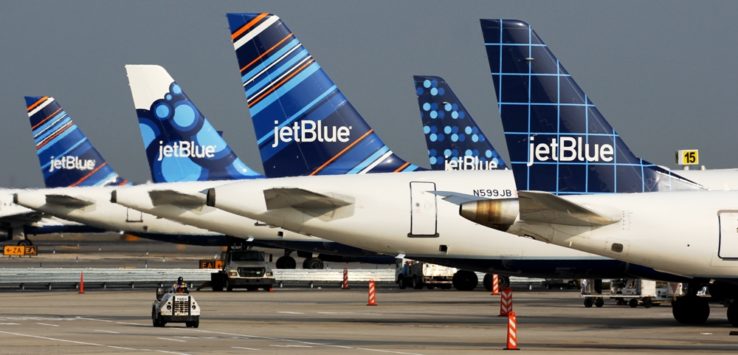 a group of airplanes parked on a runway