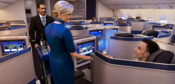 a woman in a blue dress standing in a row of rows of chairs