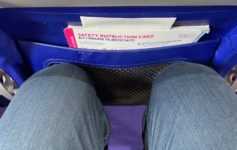 a person's legs in a blue bag with a safety instructions