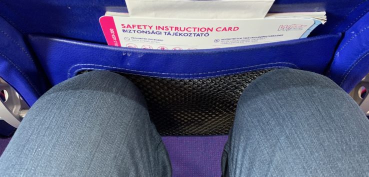 a person's legs in a blue bag with a safety instructions