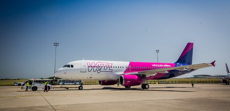 a white and pink airplane on a runway