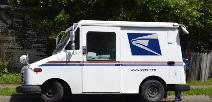 a white delivery truck parked on the side of the road