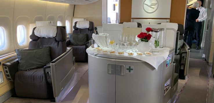 a table with glasses and flowers on it in an airplane