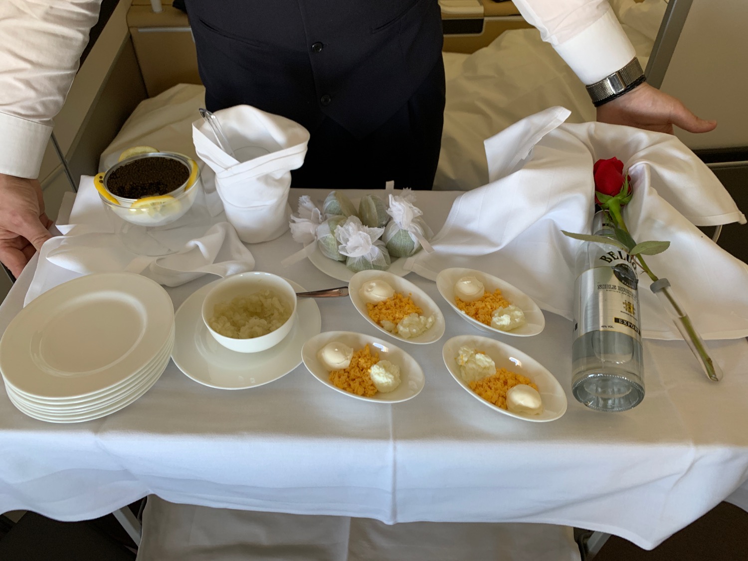 a table with plates of food and a rose