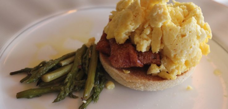 a plate of food with eggs and asparagus