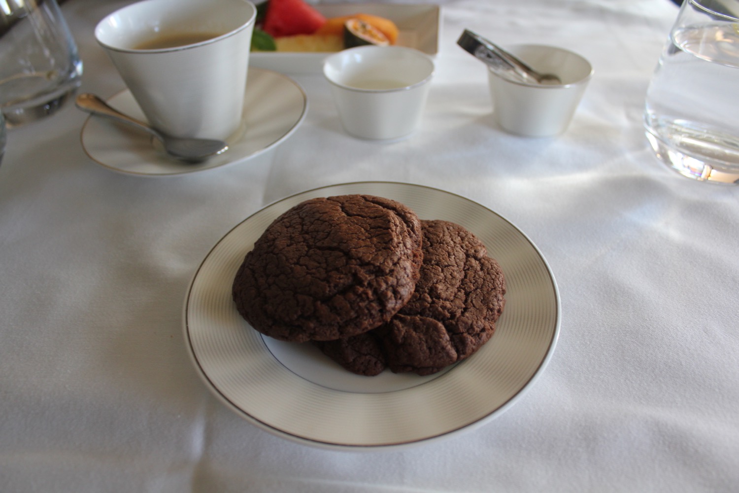 a plate of cookies and cups of coffee