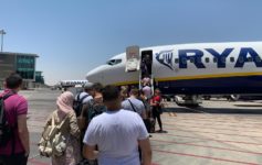 people boarding an airplane at an airport