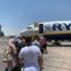 people boarding an airplane at an airport