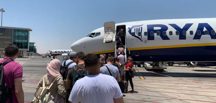 people boarding an airplane at an airport