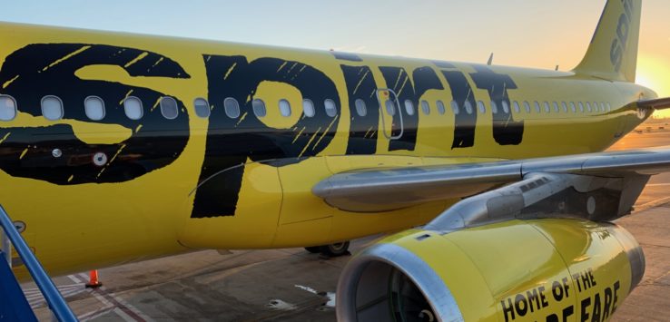 a yellow airplane with black text on it