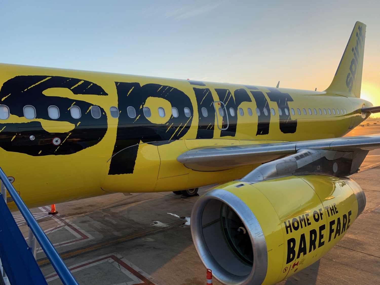 a yellow airplane with black text on it