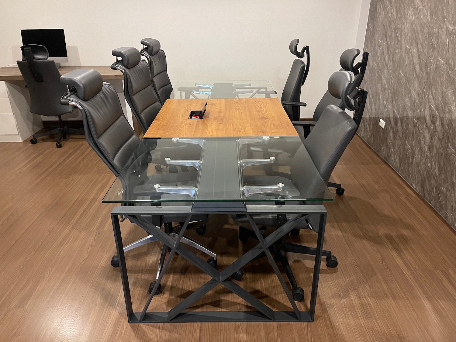 a glass table with chairs around it