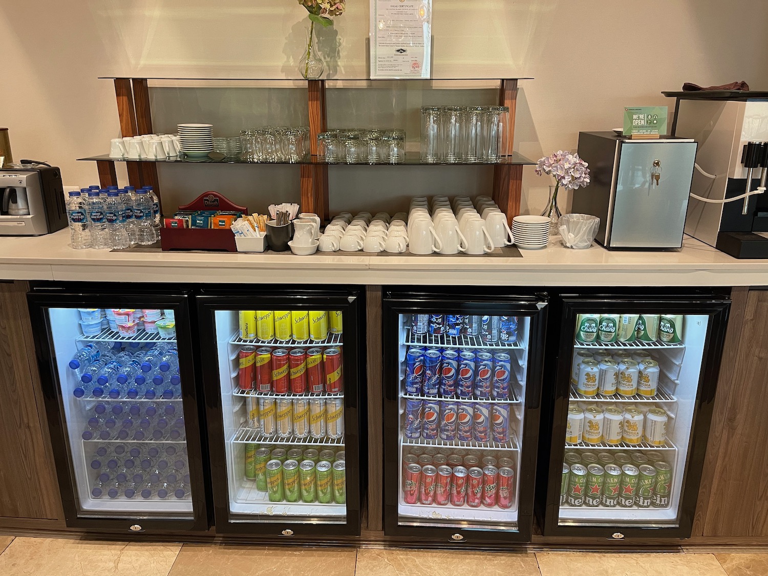 a fridge with drinks and cups on it