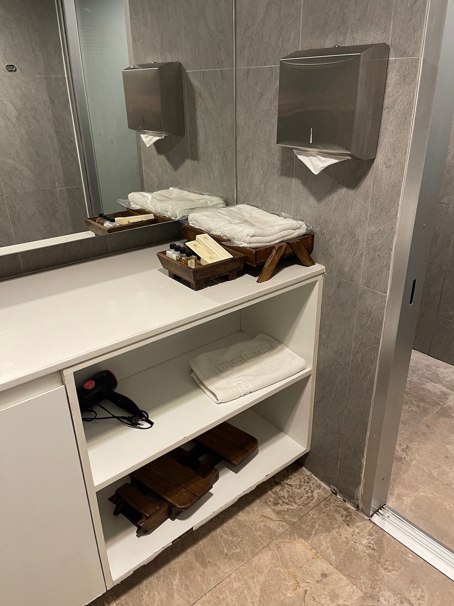 a bathroom with a mirror and shelves