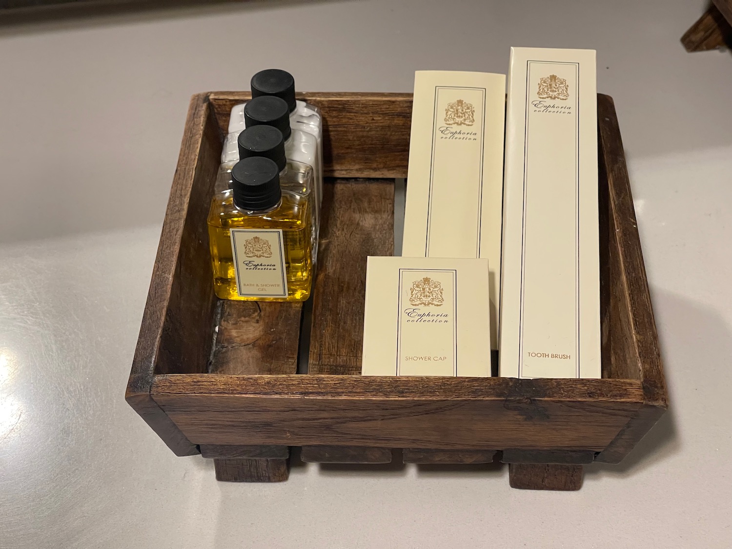 a wooden box with small bottles of liquid and boxes