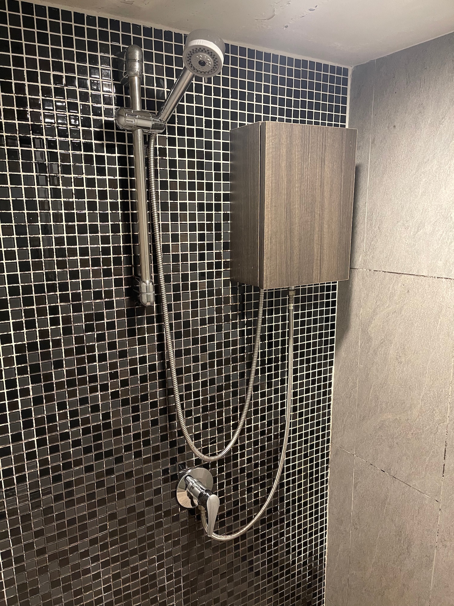 a shower with a hose and a box