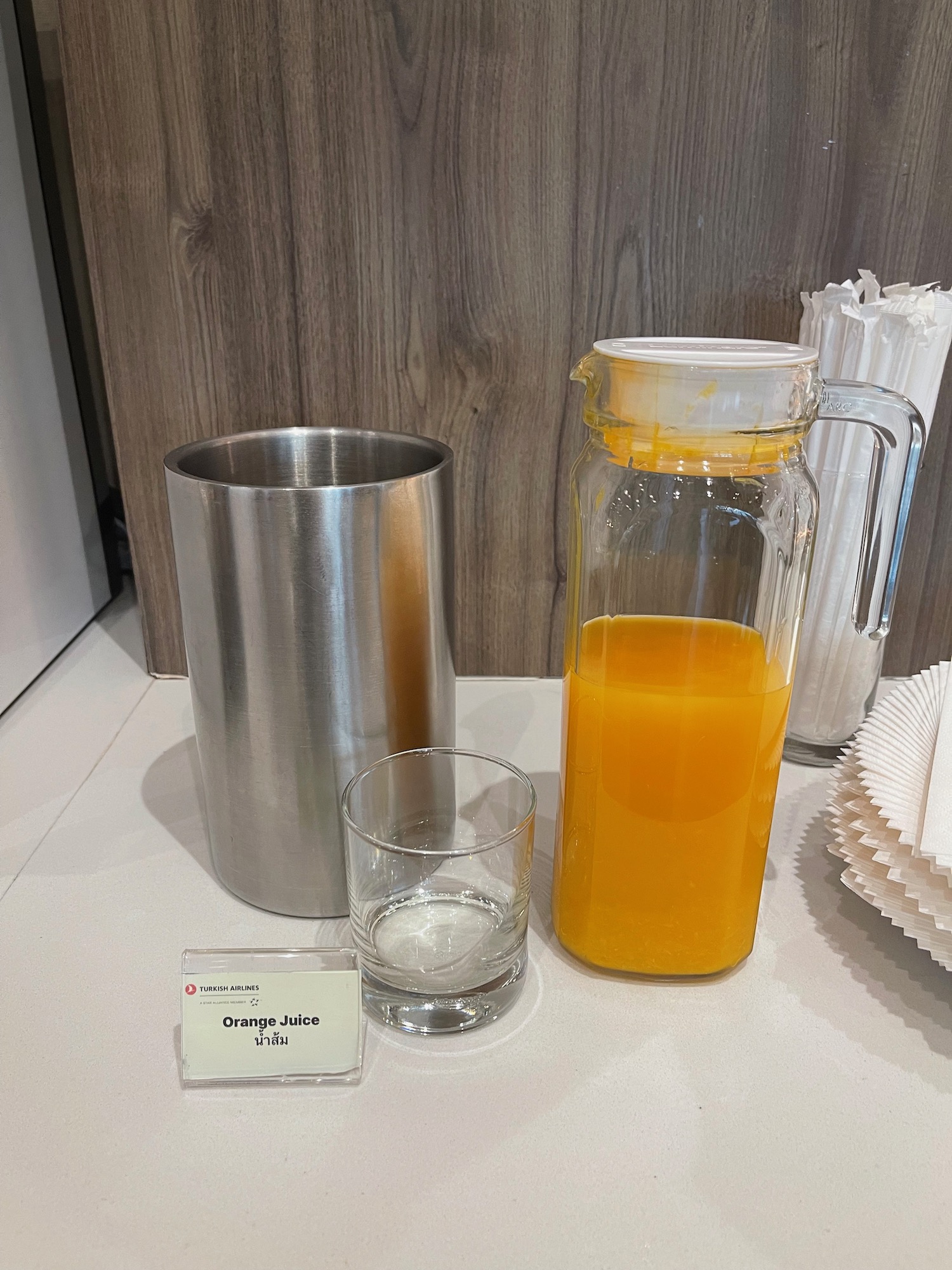 a glass and a pitcher with orange juice