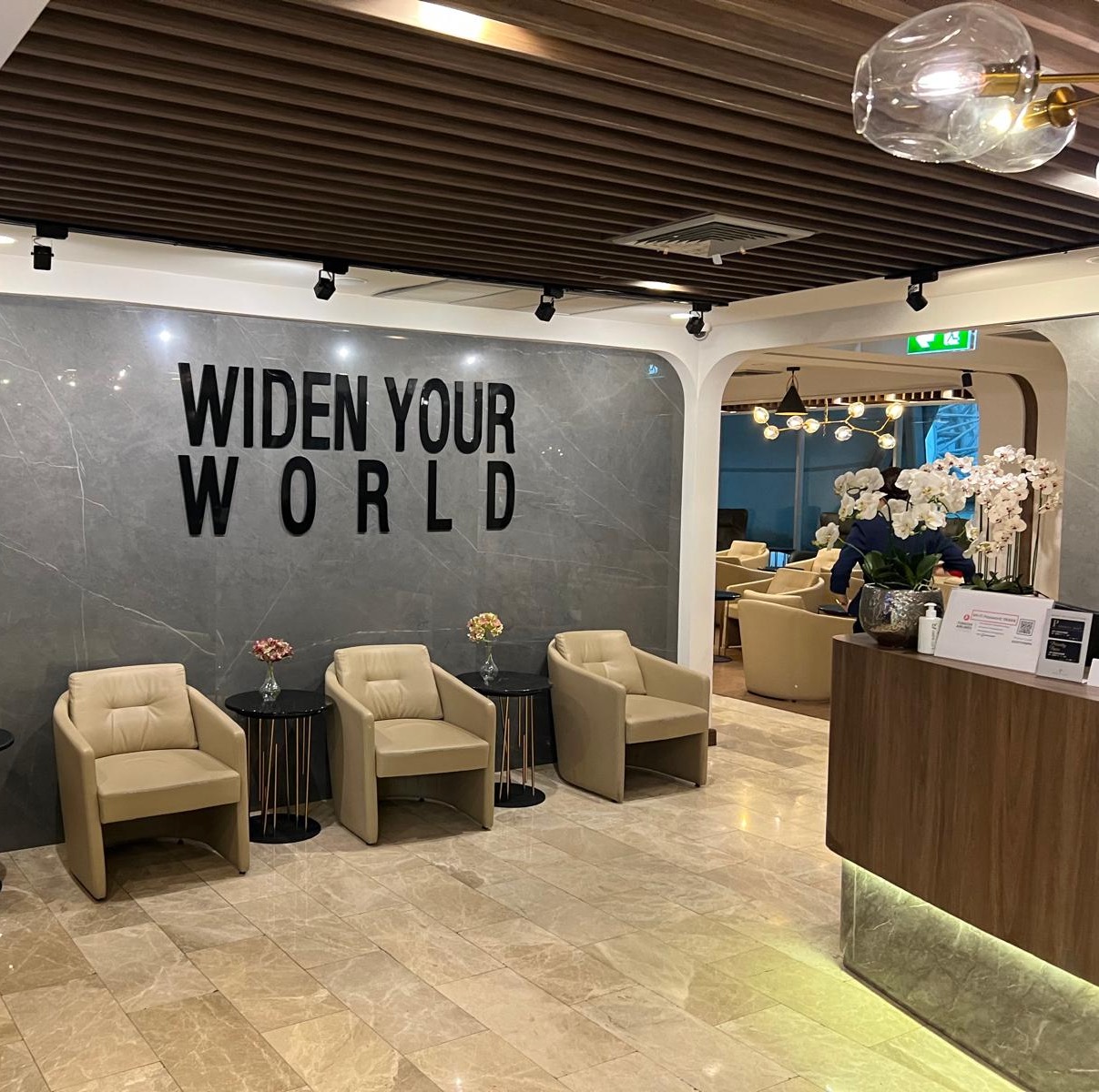 a reception area with chairs and a sign