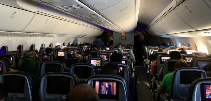 a group of people sitting in an airplane