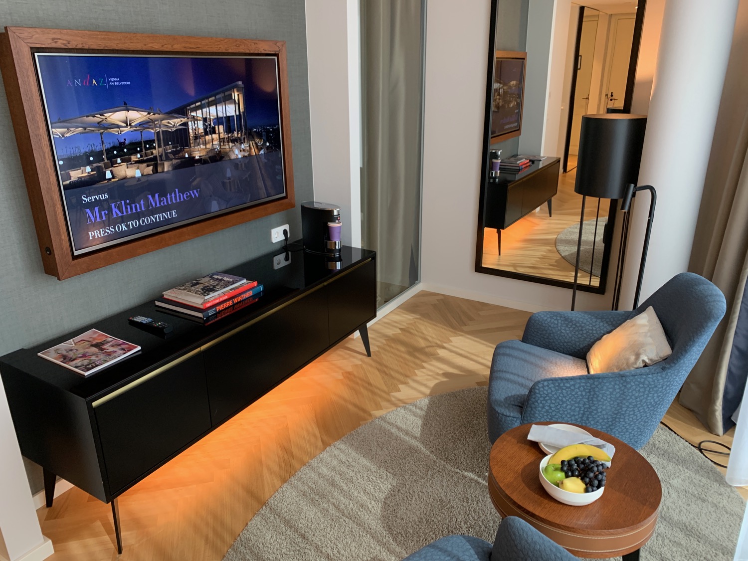 a living room with a television on the wall