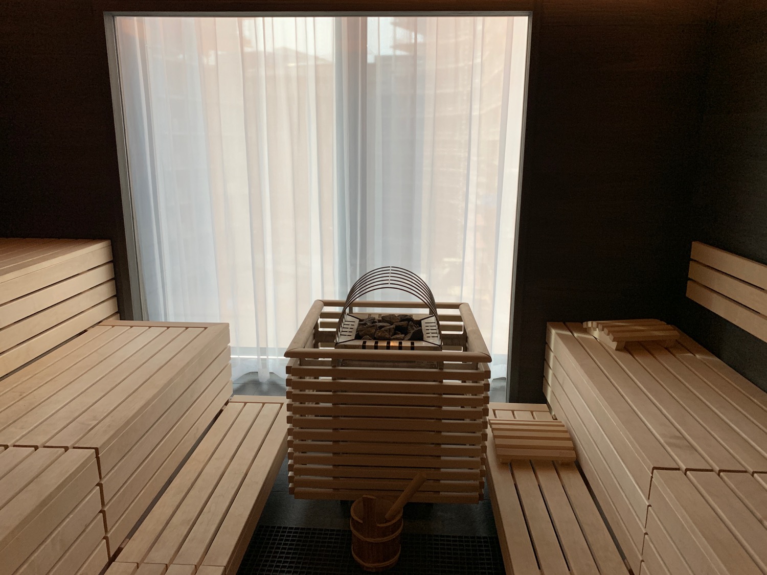 a sauna with a basket and benches