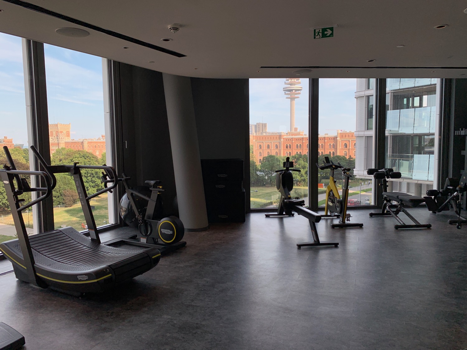 a room with exercise equipment and windows