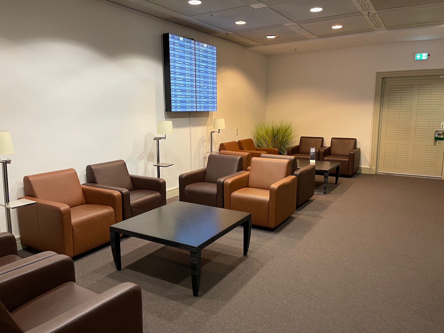 a room with brown chairs and a table