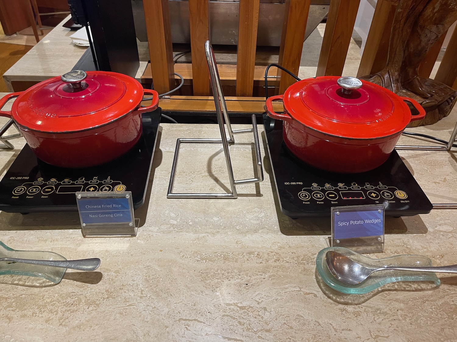 a two red pots on a counter