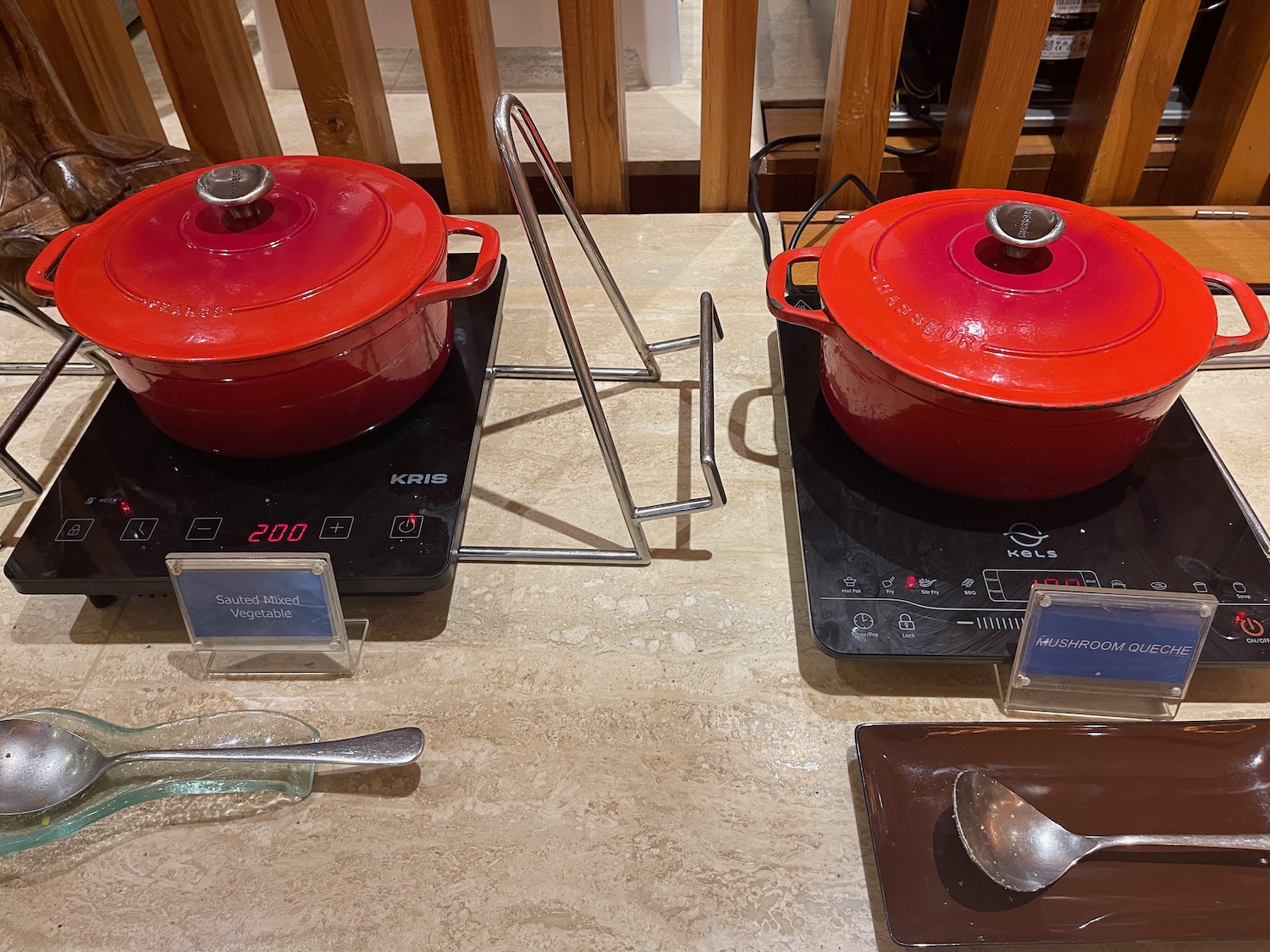 two red pots on a counter