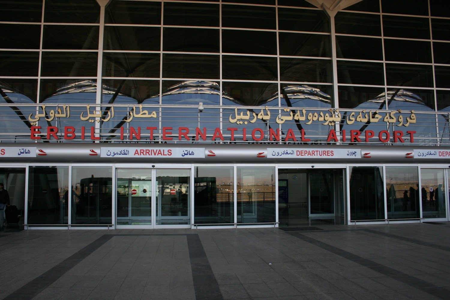 a glass building with a sign on the front