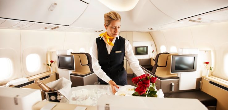 a woman serving food in an airplane