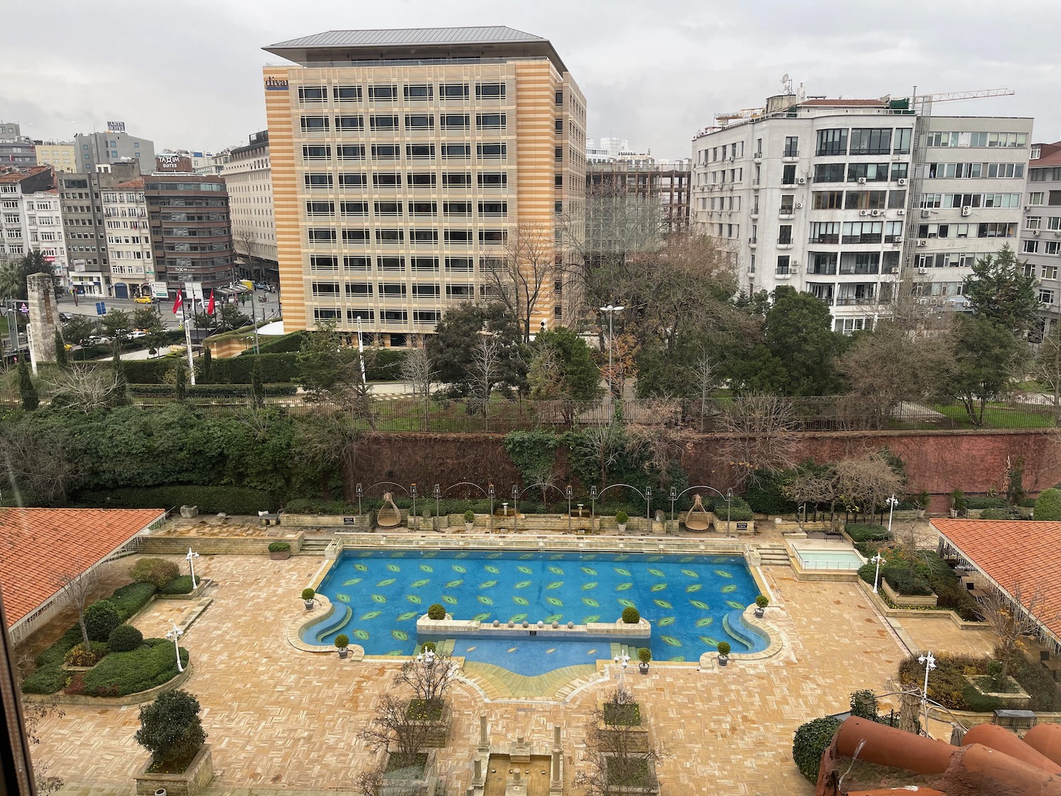 a pool with a fountain in a city