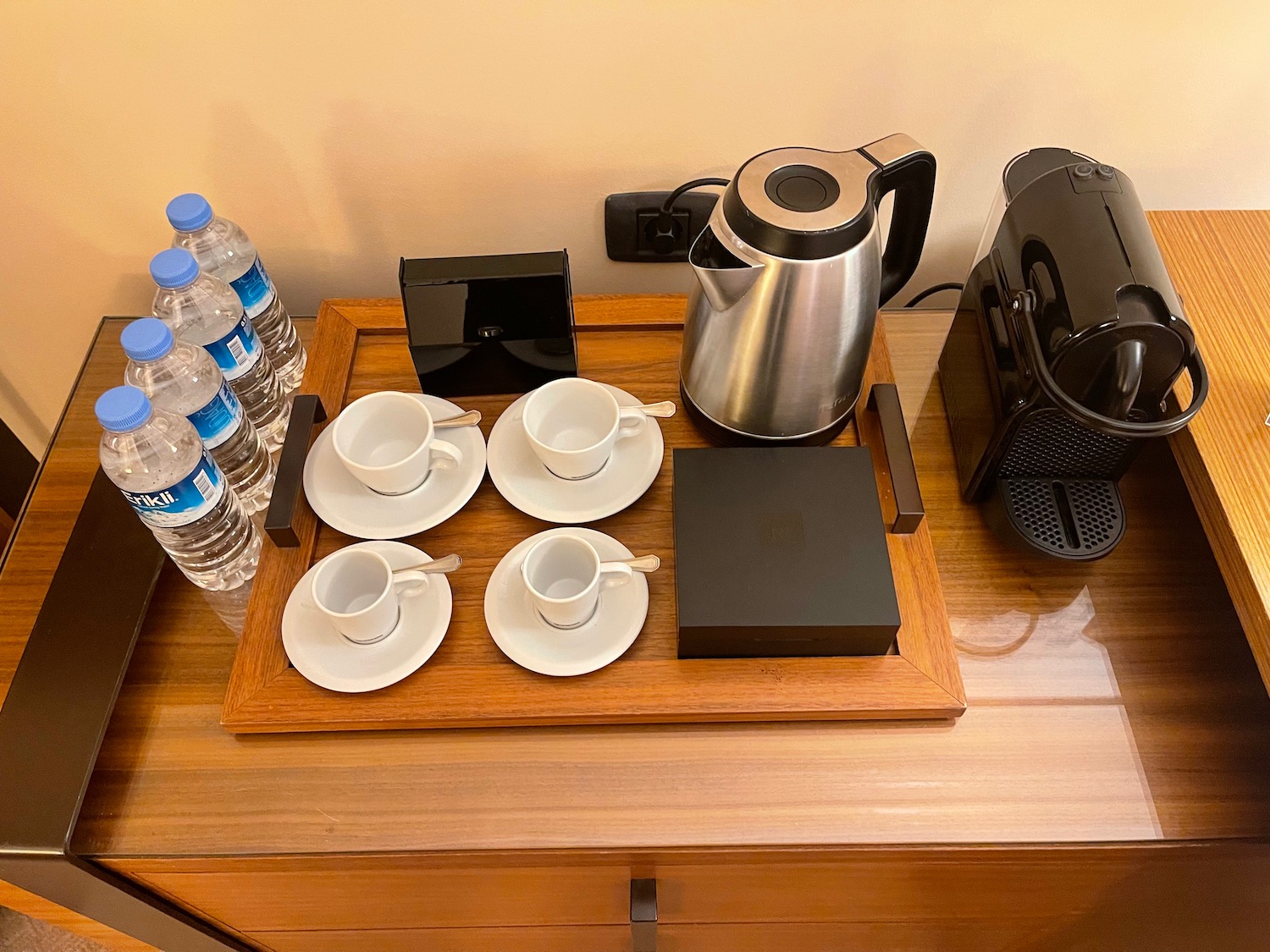 a tray with tea cups and saucers on it