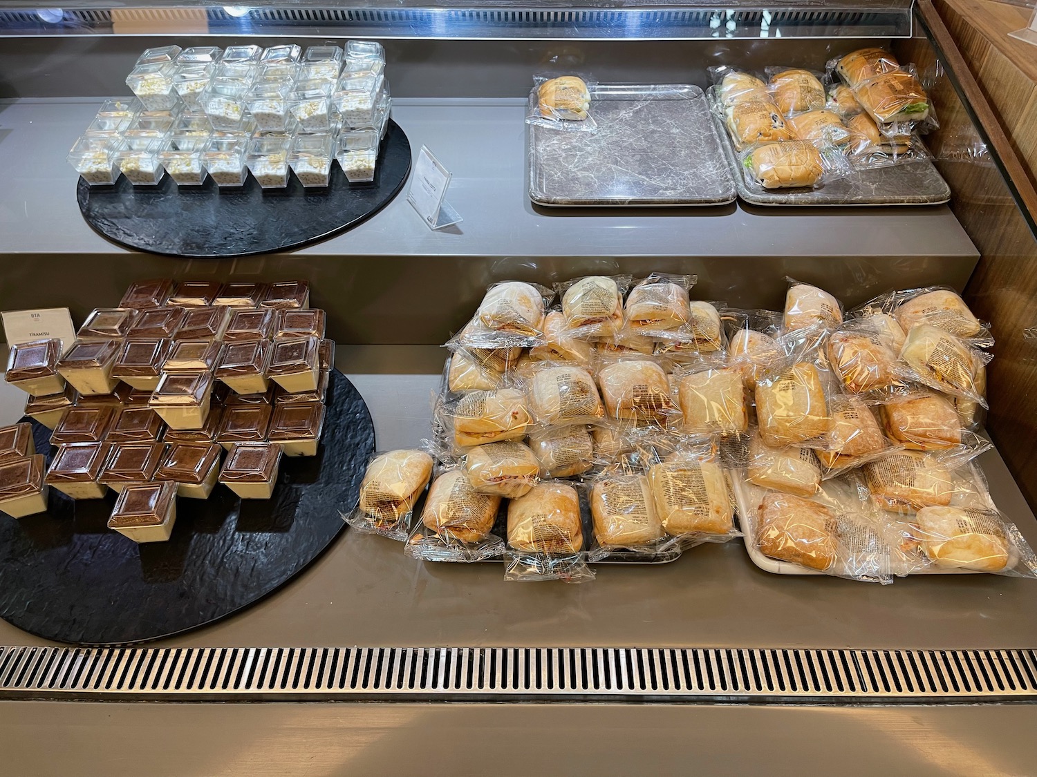 a trays of pastries wrapped in plastic