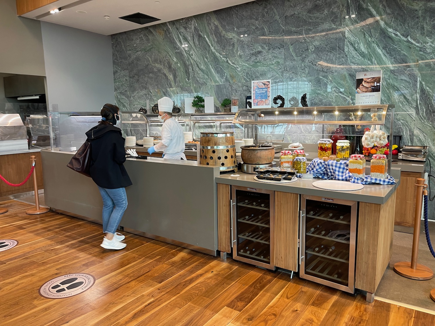 a woman standing at a counter in a restaurant