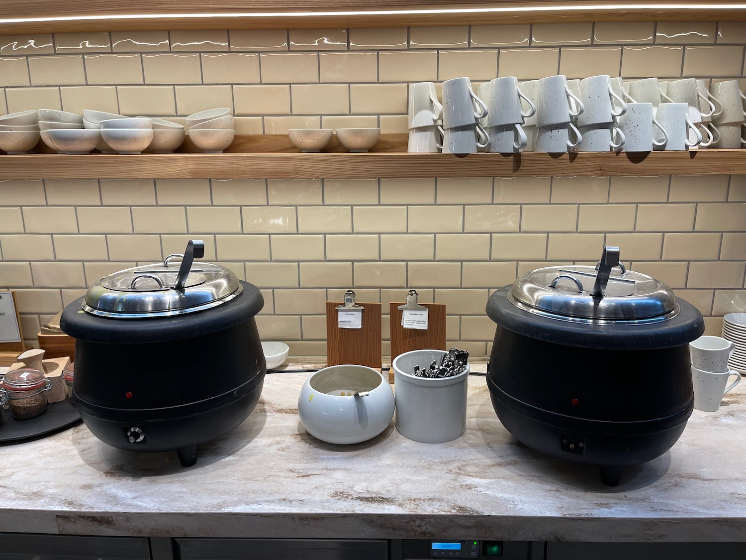 a kitchen counter with pots and bowls