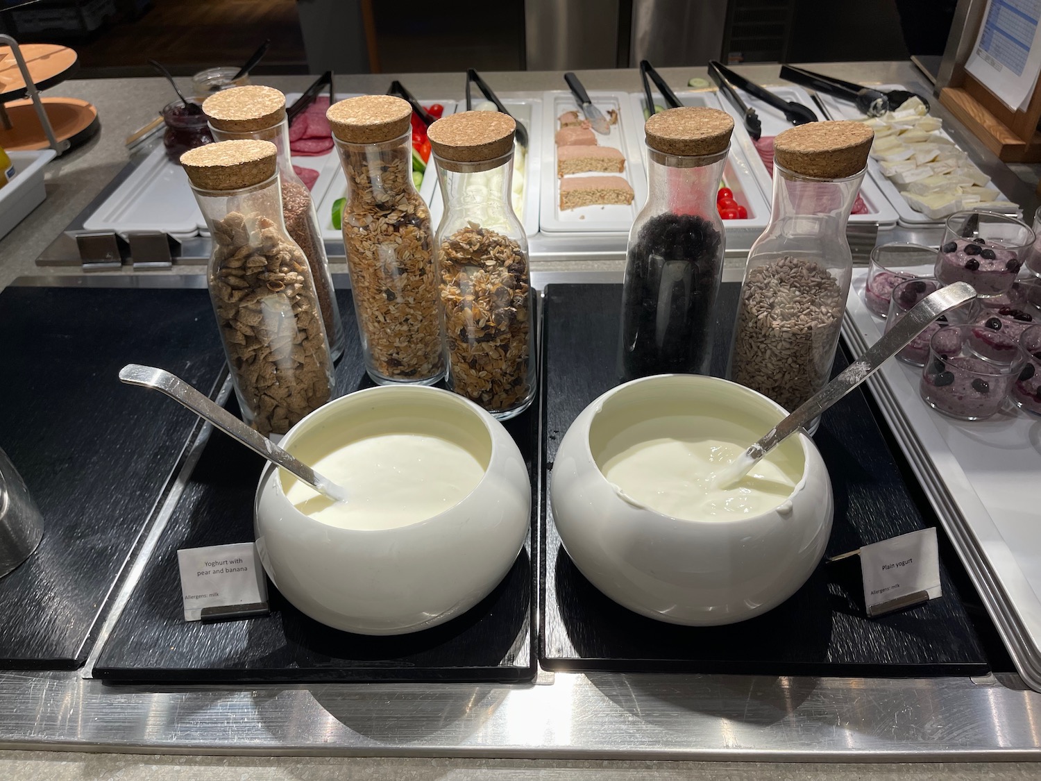 a group of jars of food and a bowl of yogurt