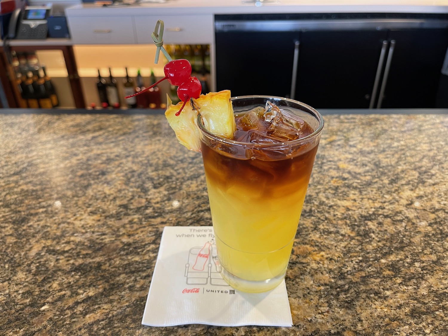 a glass with a drink and a fruit on it