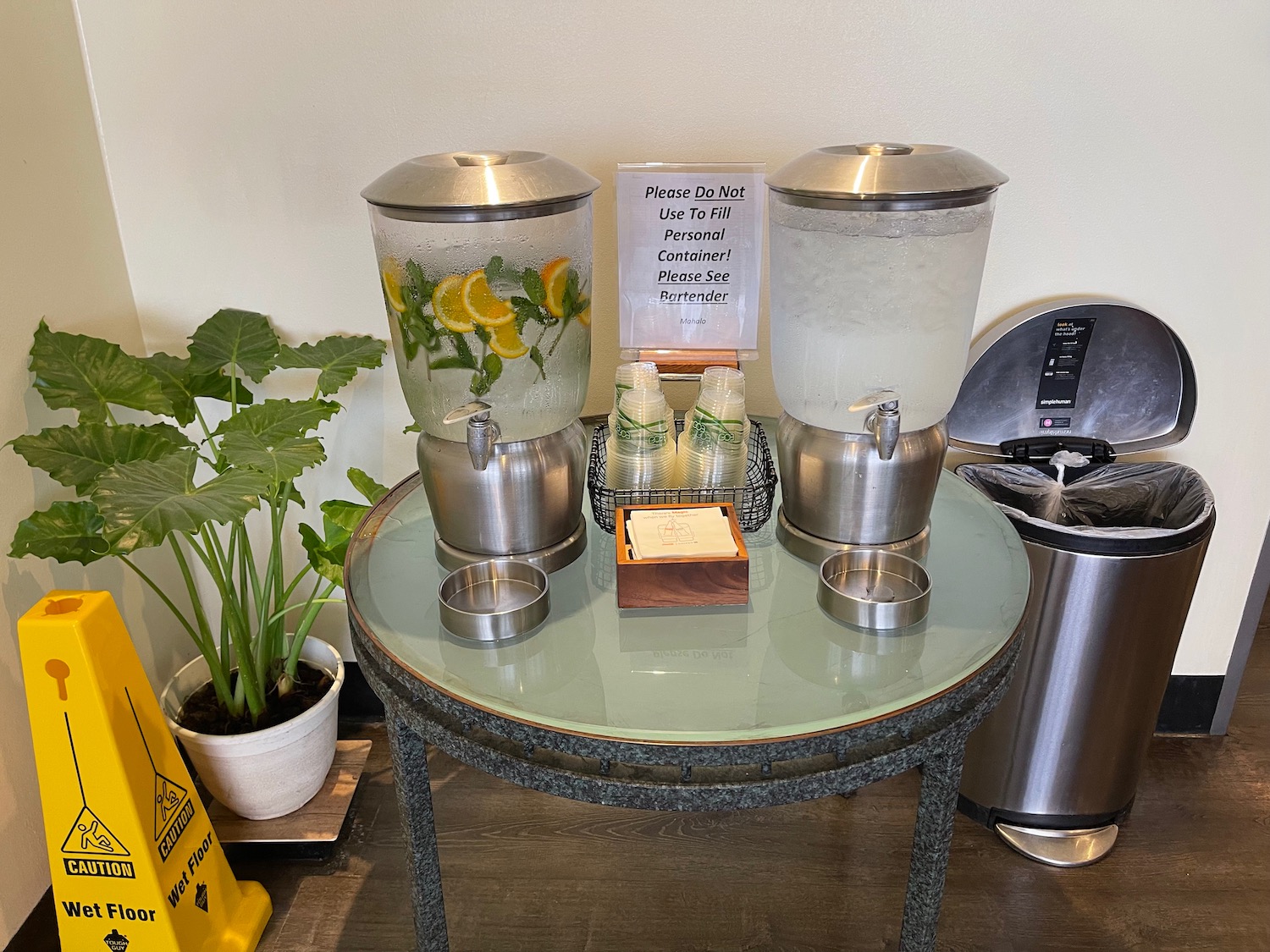 a table with a drink dispenser and a drink dispenser