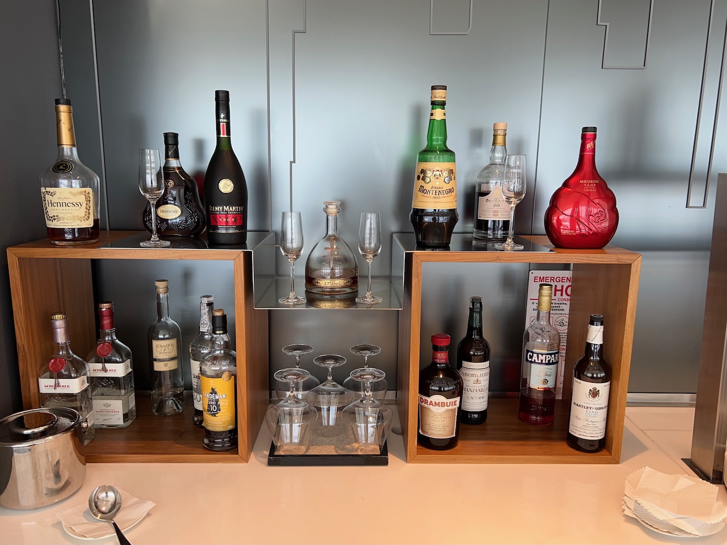 a group of bottles and glasses on shelves