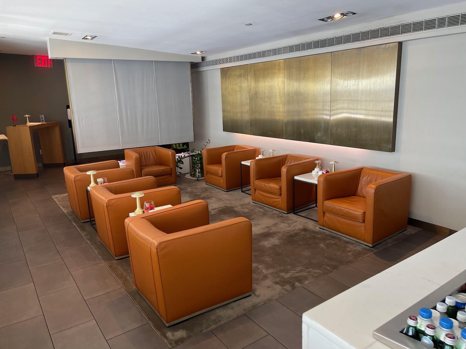 a room with brown leather chairs and tables