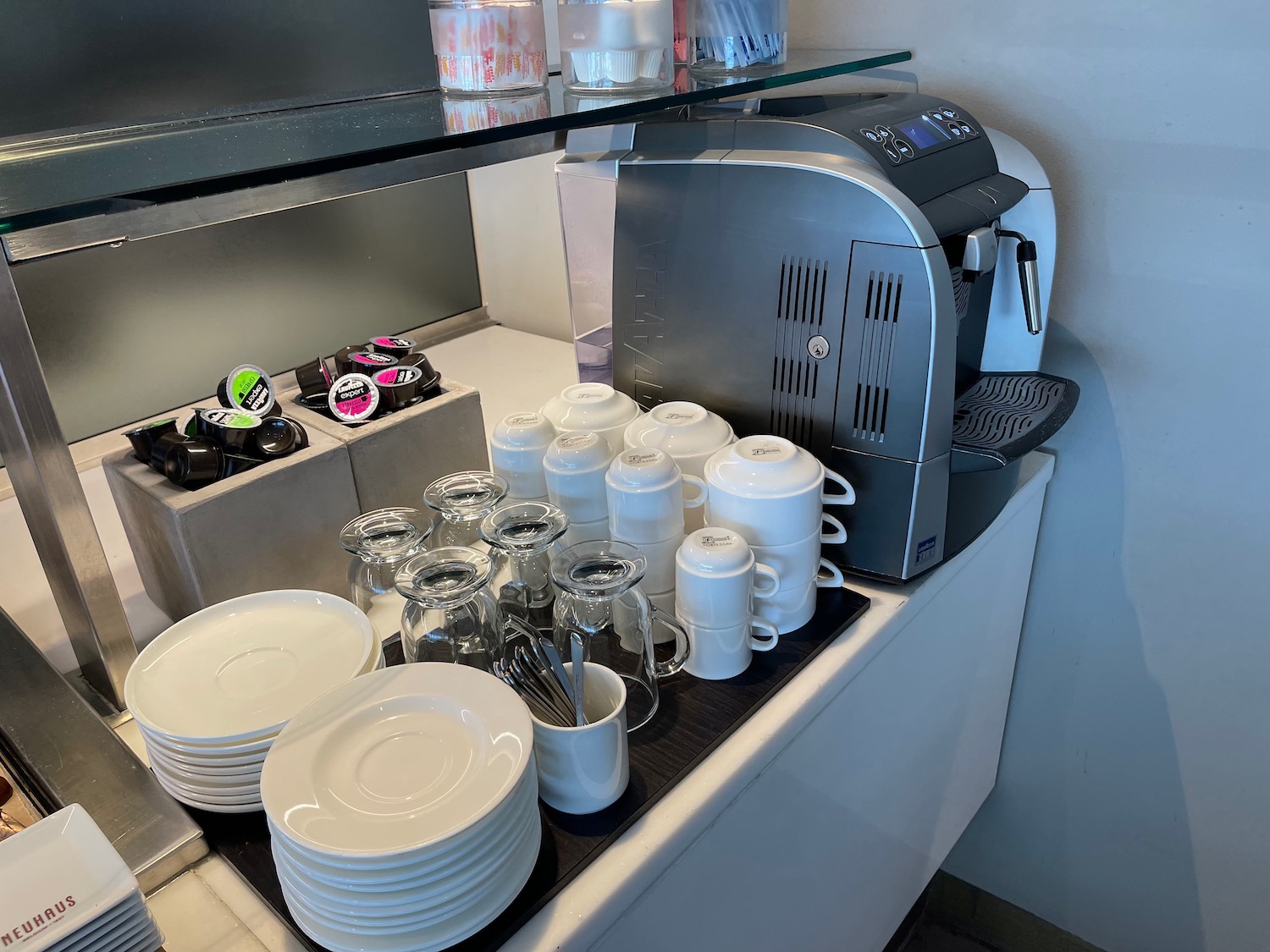 a coffee machine and plates on a counter