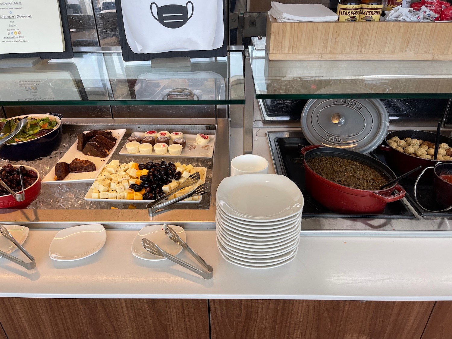 a buffet with plates and food on the counter