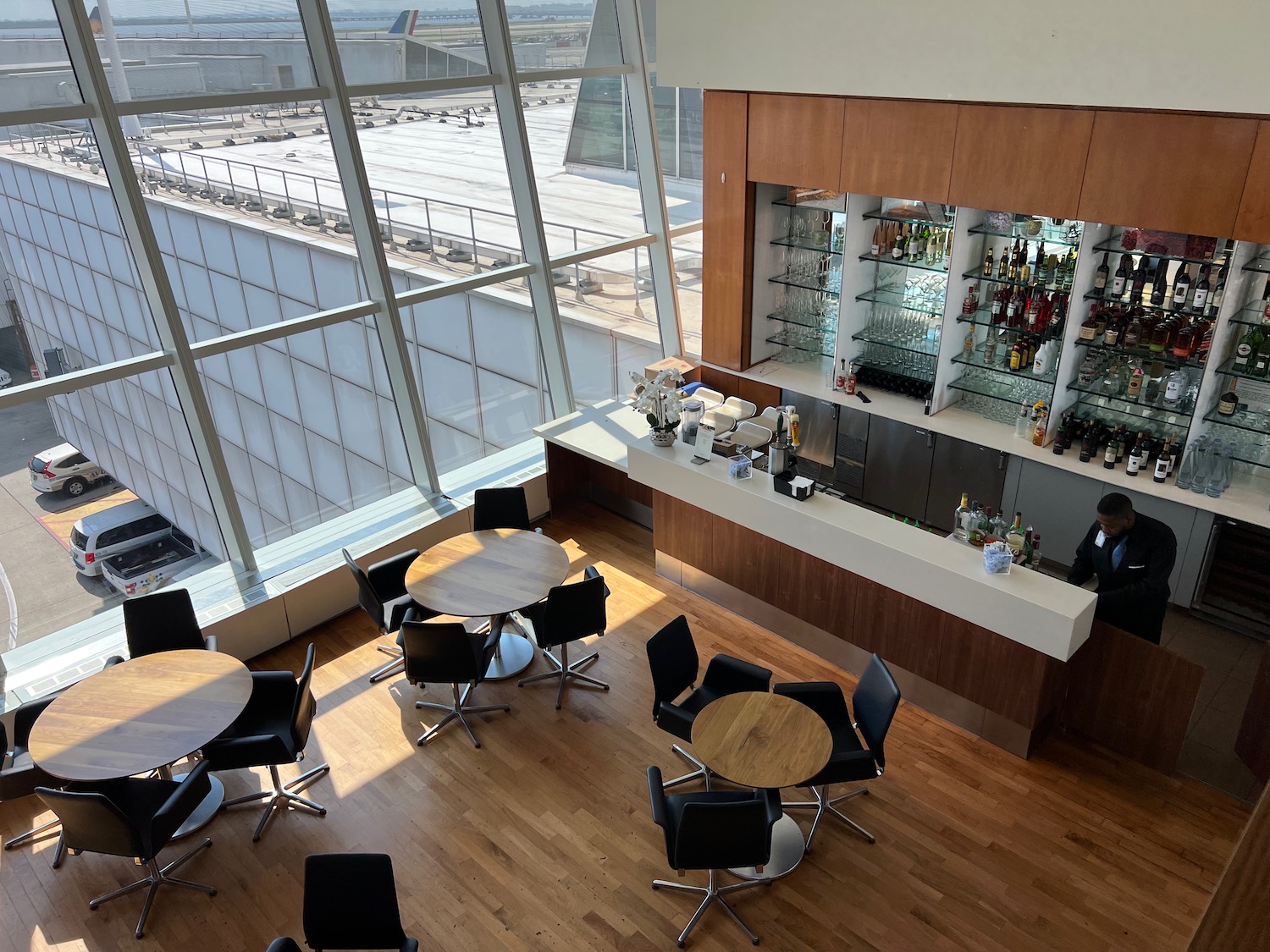 a room with a bar and tables and chairs