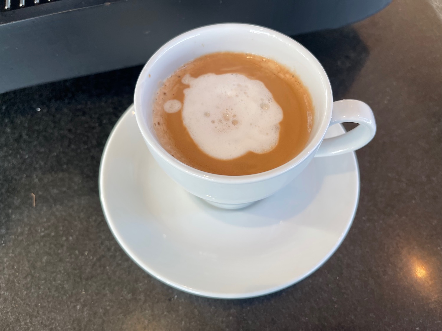 a cup of coffee with foam in it