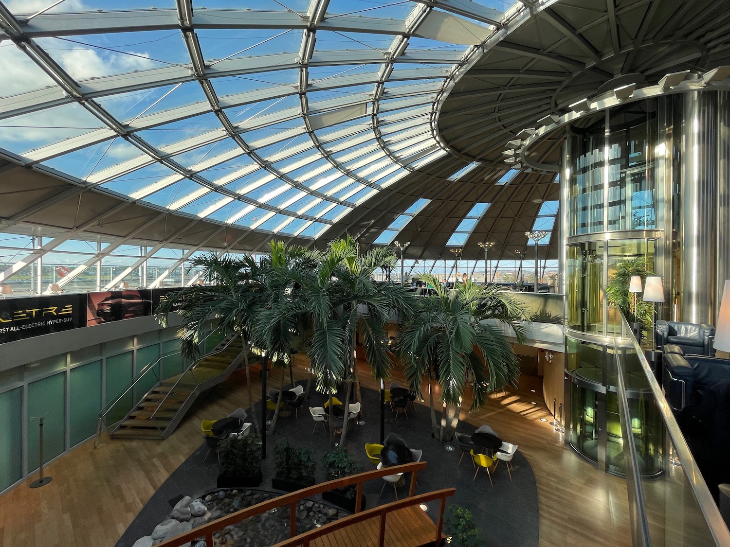 a glass dome with a glass ceiling and a large tree