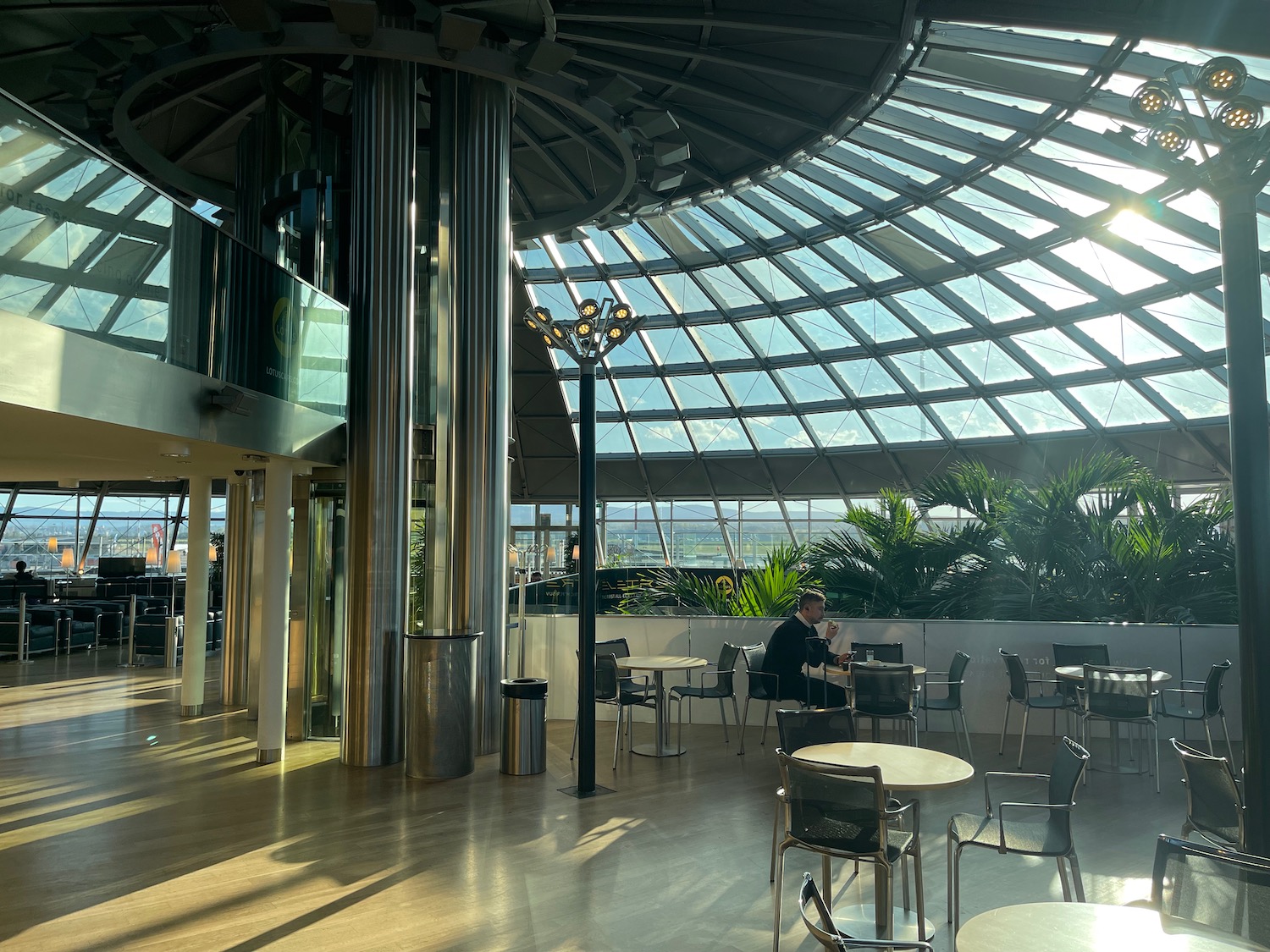 a glass dome with a person sitting at tables