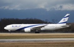 a large white and blue airplane on a runway