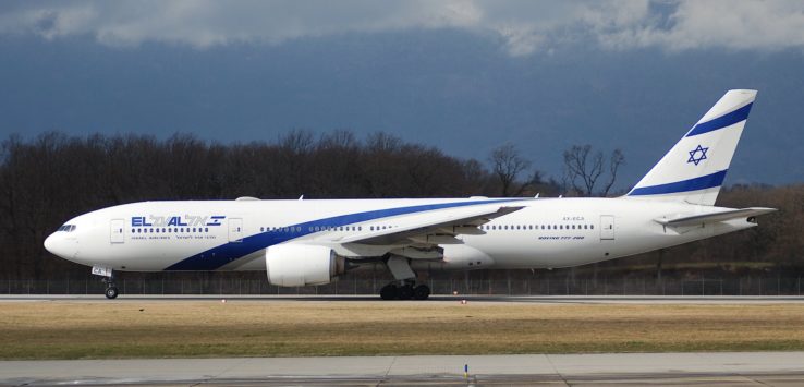 a large white and blue airplane on a runway